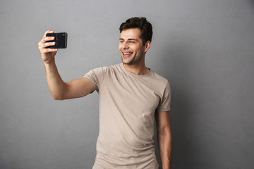 Poster - Portrait of a cheerful young man in t-shirt