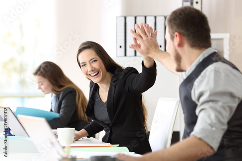 Fotografía Two happy coworkers celebrating success at office