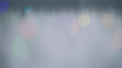 Poster - Glowing geometric abstract background with colorful defocused lights. 4K resolution trucking shot.