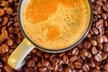 a cup of coffee on a background of coffee beans