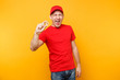 © ViDi Studio - Delivery man in red uniform isolated on yellow orange background. Professional excited male employee in cap, t-shirt courier dealer holding bitcoin, metal golden bit coin. Service concept. Copy space.