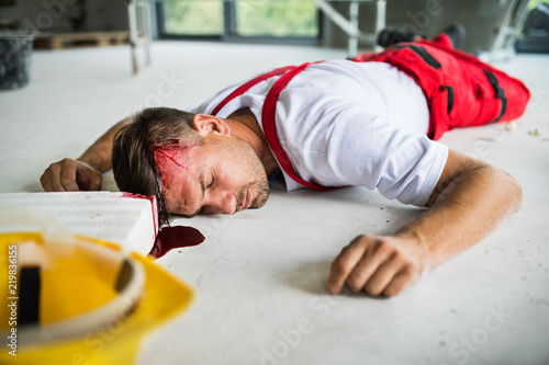 Cuadros en Lienzo An unconscious man worker lying on the floor after accident on the construction site