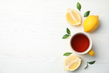 Cup Of Black Tea And Lemons On Wooden Table, Top View