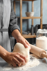 Wall Mural - Woman kneading dough for pastry on table