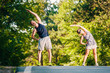 © qunica.com - Young fit couple warming legs and prepare to jogging