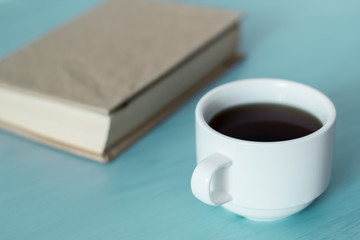 A cup of coffee and a book. 