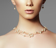 © looking2thesky - Beautiful woman in a necklace, earrings. Model in jewelry from precious stones, diamonds. Beautiful part of female face. Perfect clean skin