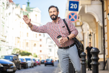 Pleasant bearded man waiting for a ride