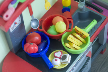 Budapest, Hungary - 07/30/2018: Girl's plastic kitchen for playing with various colors in the room.