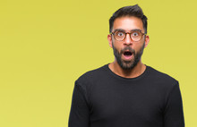 Adult Hispanic Man Wearing Glasses Over Isolated Background Afraid And Shocked With Surprise Expression, Fear And Excited Face.