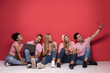 © neonshot - Young multiracial people with mobile phones.