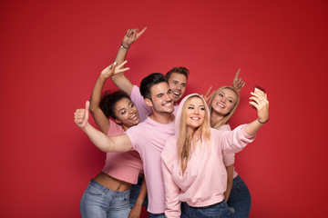 Group of people taking selfie.