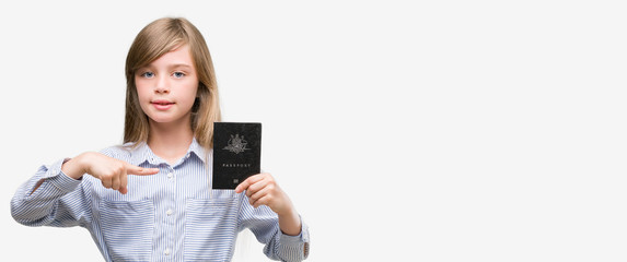 Sticker - Young blonde toddler holding australian passport very happy pointing with hand and finger