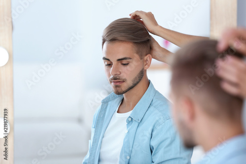 Professional Hairdresser Working With Young Man In Barbershop