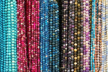 Colorful Beads Background. Background Pattern Of Multicolored Natural Stone Beads. String Of Beads In Various Colors. Colorful Beads Necklaces. Handicraft Fashionable For Women