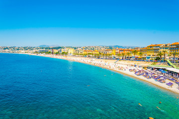 People are enjoying summer on a beach in Nice, France