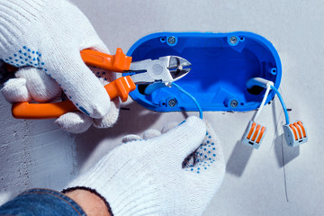 Wall Mural - Electrician installing electricity in a new house. Concept repair household power.