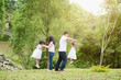 © WONG SZE FEI - Asian family play jumping at outdoor park.