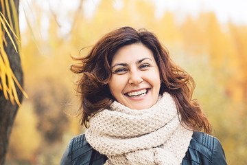 happy autumn woman laughing in fall park outdoors, portrait