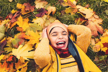 Cute little child boy having fun in autumn park, portrait