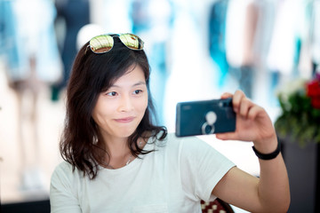 Young woman using smartphone in restaurant