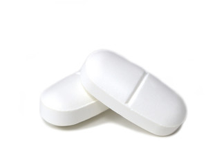 Close-up of two pills isolated on a white background