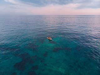 BUDVA, MONTENEGRO - July 21, 2018: two people at surfboard on sea on sunset