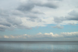 Fototapeta Morze - Gloomy blue gray sky and clouds over Lake Ladoga