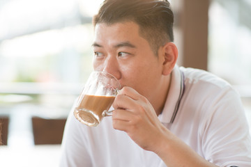 Mature man drinking milk tea