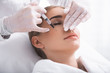 © Yakobchuk Olena - Staying calm. Attractive girl with closed eyes having skincare procedure at beauty salon. Cosmetologist hands in sterile gloves with syringe doing mesotherapy