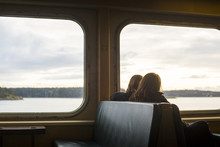 Two girls enjoying the view from their seats on a ferry in the San Juan Islands.
