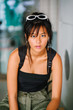 Portrait of a young Chinese Asian girl. She looks serious and is dressed in sporty attire.