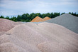 © lainen - Large piles of construction sand and gravel used for asphalt production and building. Limestone quarry, mining rocks and stones