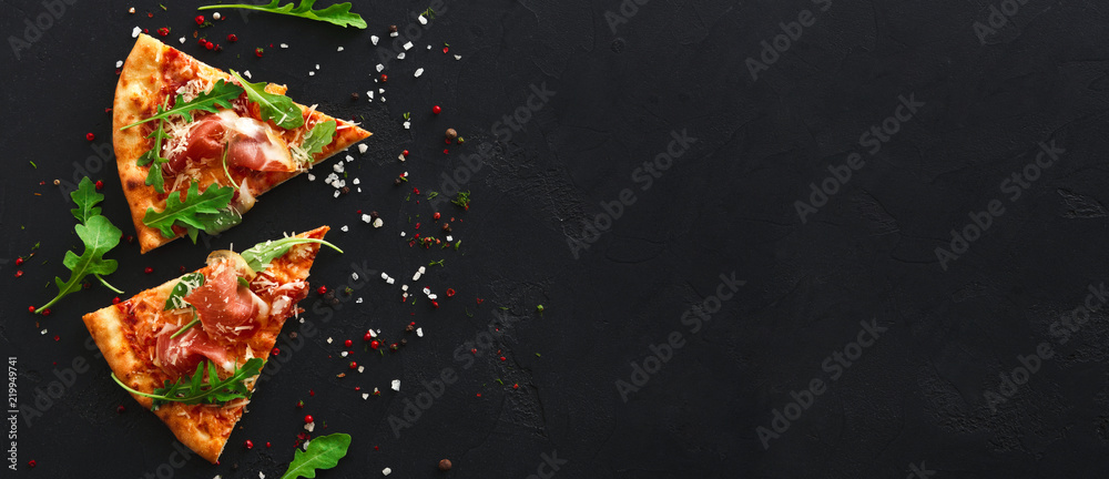 Slices of pizza with spices on black background - obrazy, fototapety, plakaty 