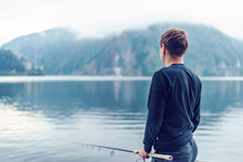 Lonely Young Man Fishing On Vidraru Lake