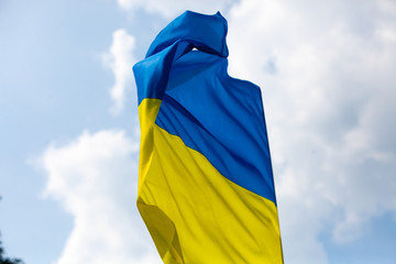 Flag of Ukraine against the blue sky. Horizontal shot.