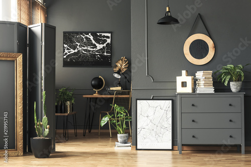 Black Painting On Grey Wall In Dark Living Room Interior