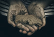 © igorbukhlin - Dirty hands of homeless poor man with piece of bread. The concept of poverty and social inequality.