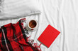 © Pixel-Shot - Cup of tea and notebook on bed linen