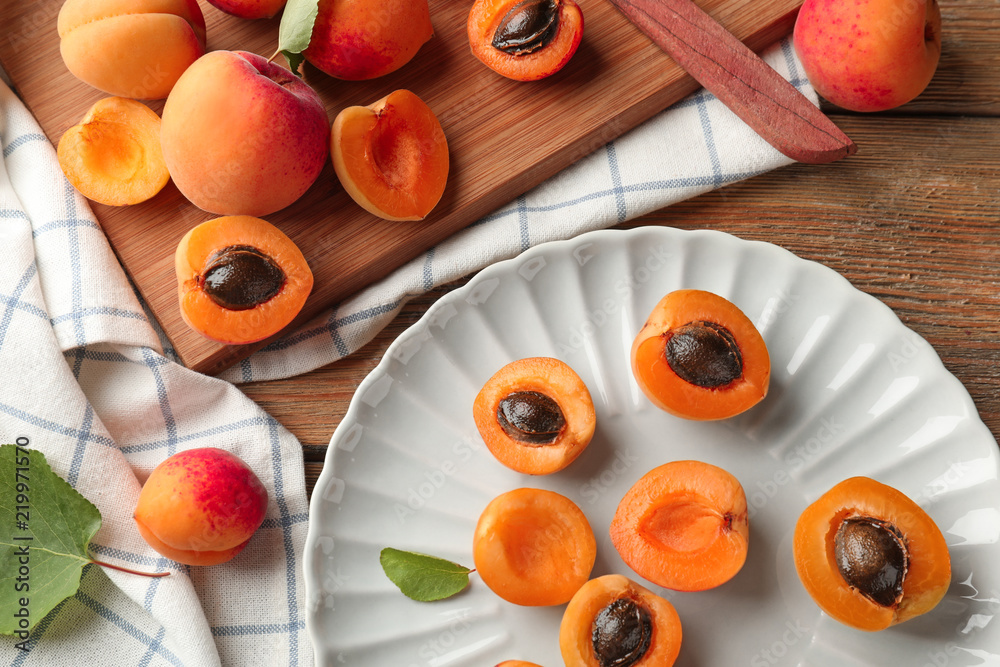 Composition with ripe sweet apricots on wooden background