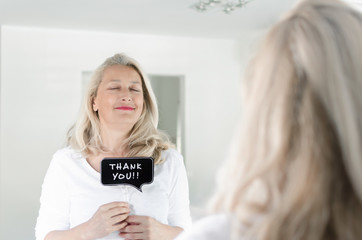 Woman holding photo prop with thank you note