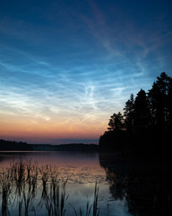 Wall Mural - night shining clouds over lake in finland