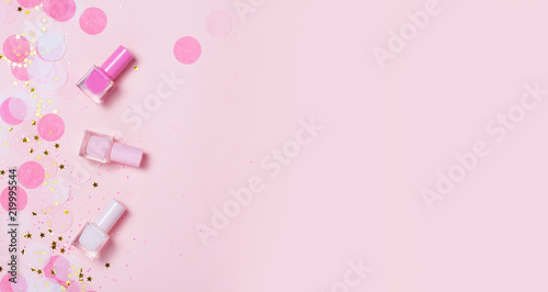 Pastel pink nail polishes and confetti, stars and sparkles. Fototapete