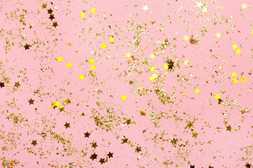 Wall Mural - Pink confetti and golden stars and sparkles on pink background.