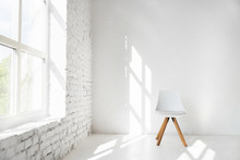 Light Minimalism Modern Scandinavian Loft Studio Interior With Cafe Furniture Chair Against White Wall Near Window. Mock Up Shadows Afternoon Pattern Copy Space Background.