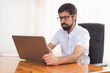© herraez - Worried expression young bearded man working at the office