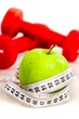 © BillionPhotos.com - Measuring Tape Wrapped Around An Apple With Hand Weights