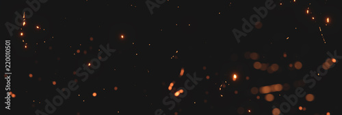 Fotografía blurred sparks from fire in front of black backgound
