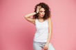 © opolja - Image of happy young lady standing isolated over pink background. Looking camera pointing.