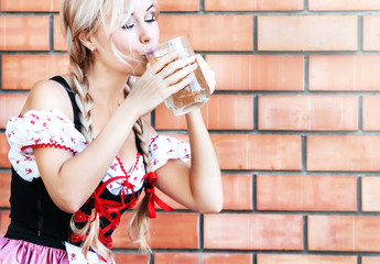 Beautiful woman with beer in Octoberfest dress.
